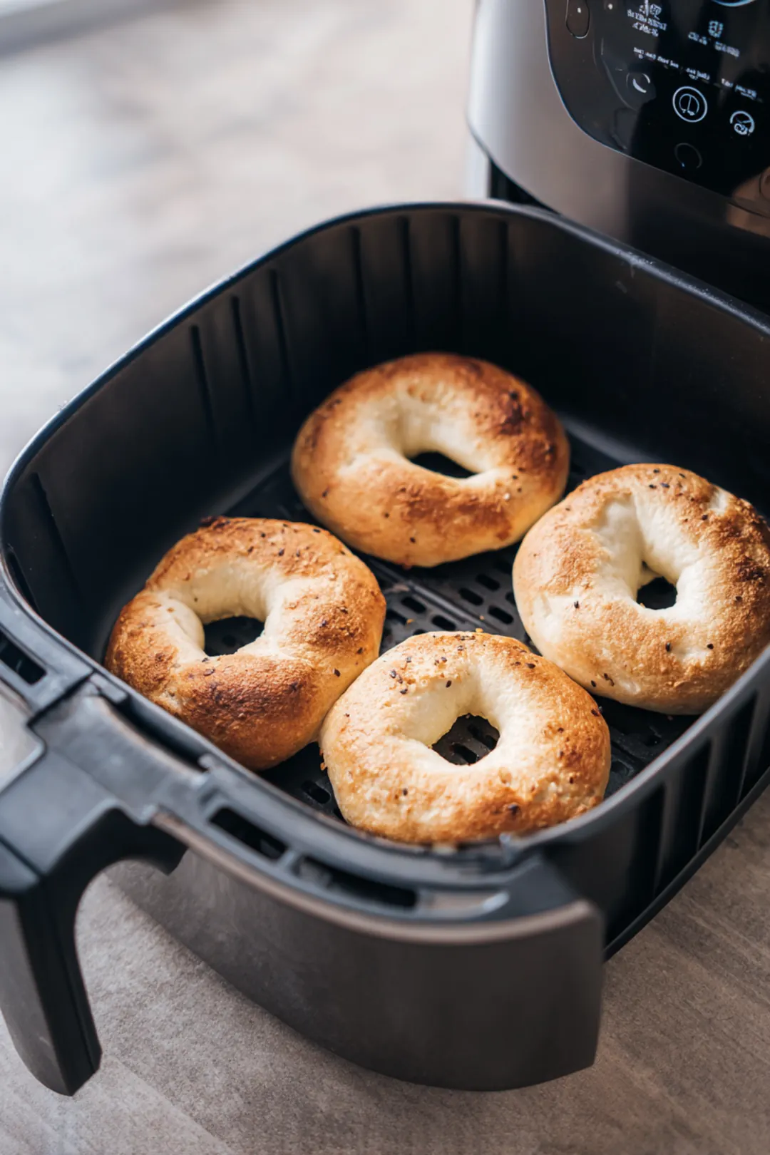 Place frozen bagels in the air fryer basket