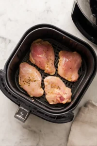 Place marinated chicken in air fryer and cook for 25 minutes