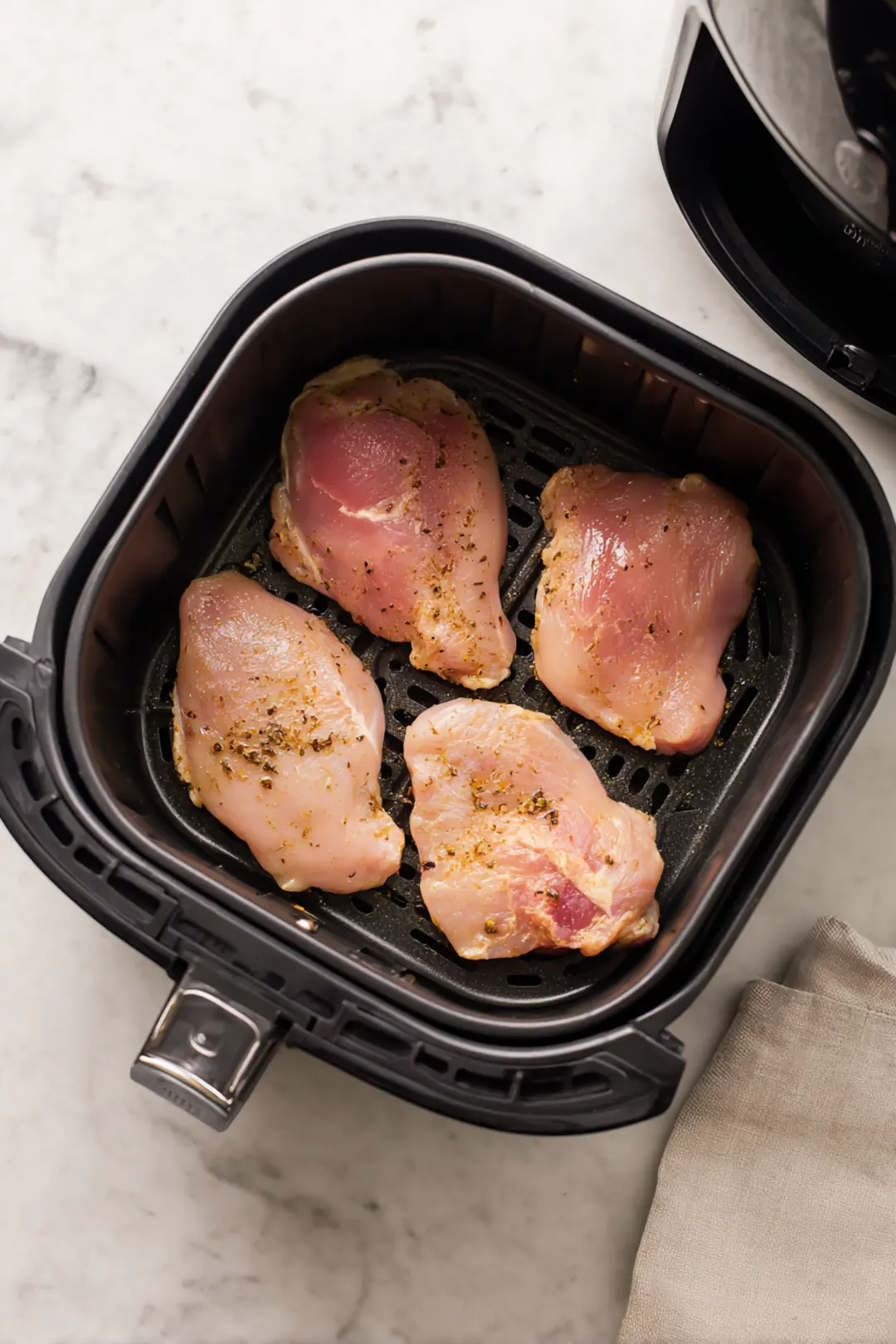 Place marinated chicken in air fryer and cook for 25 minutes