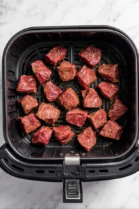 Place marinated steak bites in air fryer