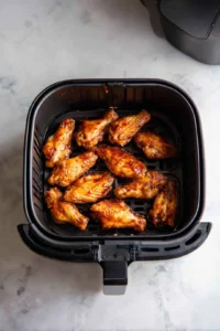 Place marinated wings in air fryer and cook at 400°F