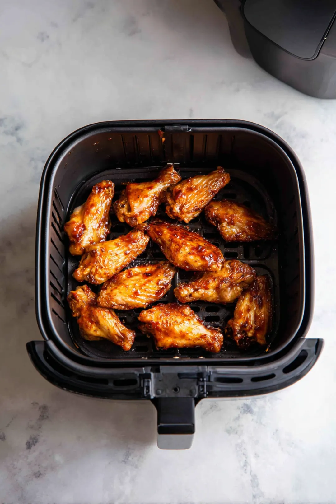 Place marinated wings in air fryer and cook at 400°F
