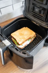 Place sandwich in air fryer basket and cook for 8-10 minutes flipping halfway through until bread is golden and cheese is melted