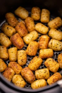 Place seasoned gnocchi in air fryer basket and cook for 15 minutes, shaking halfway through