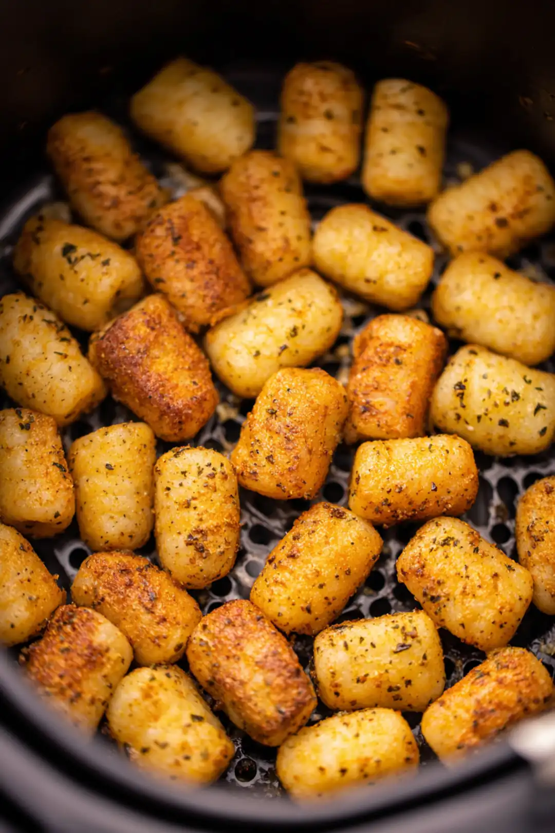 Place seasoned gnocchi in air fryer basket and cook for 15 minutes, shaking halfway through