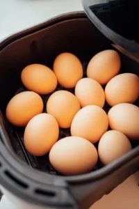 Place the eggs in the air fryer basket, ensuring they are not overcrowded. Cook for 12-15 minutes depending on the desired doneness (12 minutes for soft boiled, 15 minutes for hard boiled).