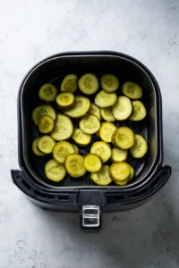 Place the pickles in the air fryer basket in a single layer and cook for 10-15 minutes, shaking halfway through, until crispy.