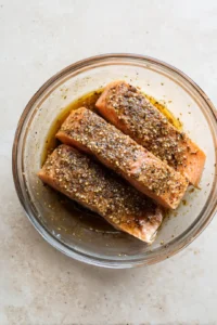 Place the salmon in the air fryer and cook until flaky