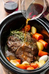 Pour beef broth and optional ingredients over the roast and cook