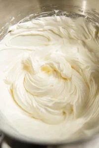 Pour cheesecake filling into the prepared pan and smooth the top with a spatula