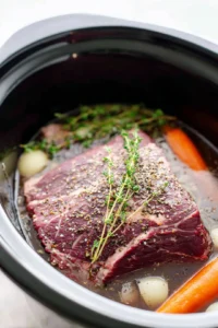 Pour the beef broth and red wine into the slow cooker
