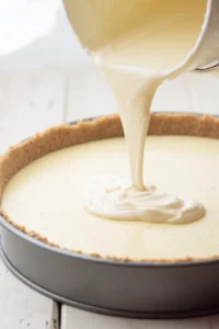 Pour the cream cheese filling over the prepared crust