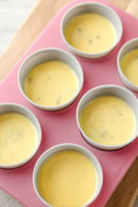 Pour the egg mixture into silicone egg bite molds and place in the air fryer