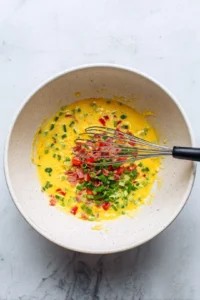 Pour the egg mixture over the cheese-covered crust and air fry until golden brown