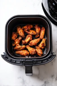 Preheat the air fryer to 375°F (190°C) for about 5 minutes. Arrange the marinated wings in a single layer in the air fryer basket. Cook for 25 minutes, flipping halfway through for even crispiness.