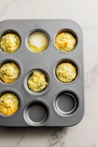 Preheat the oven to 350 degrees Fahrenheit and grease a muffin tin
