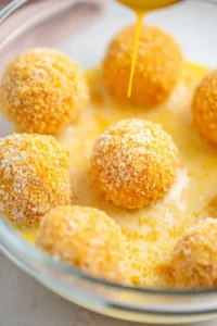 Preheat your air fryer to 350 degrees Fahrenheit and cook the coated ice cream balls until golden brown