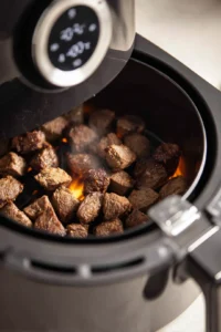 Preheat your air fryer to 400°F (200°C) for about 5 minutes to ensure the steak bites will start cooking immediately and get that perfect crisp.