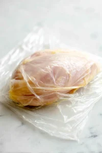 Prepare chicken breasts by pounding them to an even thickness