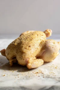 Rub the chicken with marinade for flavor