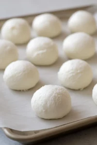 Scoop ice cream into balls and freeze on a baking sheet