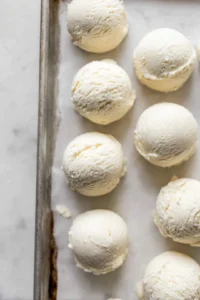 Scoop ice cream into balls and freeze on a baking sheet