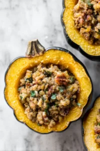 Scoop the stuffing mixture into the halved acorn squash and place in the air fryer basket. Cook for 25-30 minutes, or until the squash is tender.