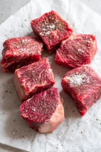 Season the ribeye pieces with salt and black pepper