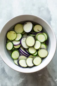 Slice eggplants into half inch rounds and soak them in water