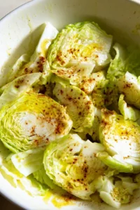Toss cabbage steaks with olive oil, garlic powder, paprika, salt, and black pepper
