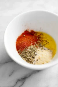 Toss corn ribs in olive oil, smoked paprika, garlic powder, sea salt, and black pepper