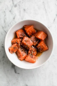 Toss salmon pieces in cornstarch until well coated