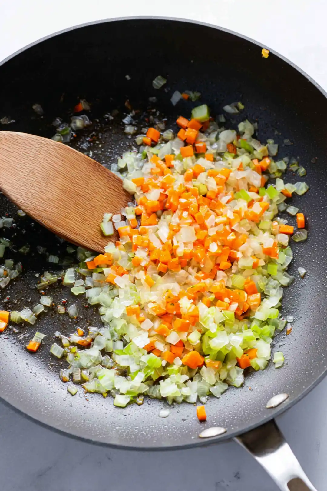 Transfer beef shank to slow cooker, sauté onions, garlic, carrots and celery until softened