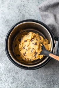Transfer the cookie dough into a greased air fryer safe dish and air fry at 320°F for about 10 minutes until golden brown