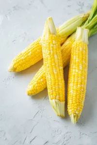 Trim the ends of the corn ears and cut them into halves or quarters