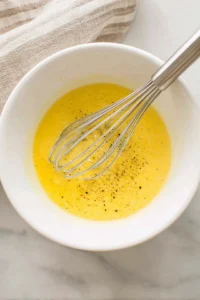 Whisk the eggs, milk, salt, and pepper until combined