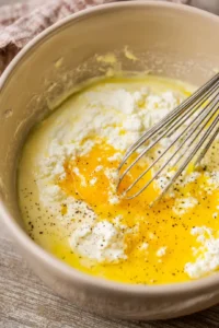 Whisk together the eggs and cottage cheese until smooth