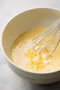 Whisk together the eggs, cream cheese, and milk until smooth and incorporate the cheddar cheese