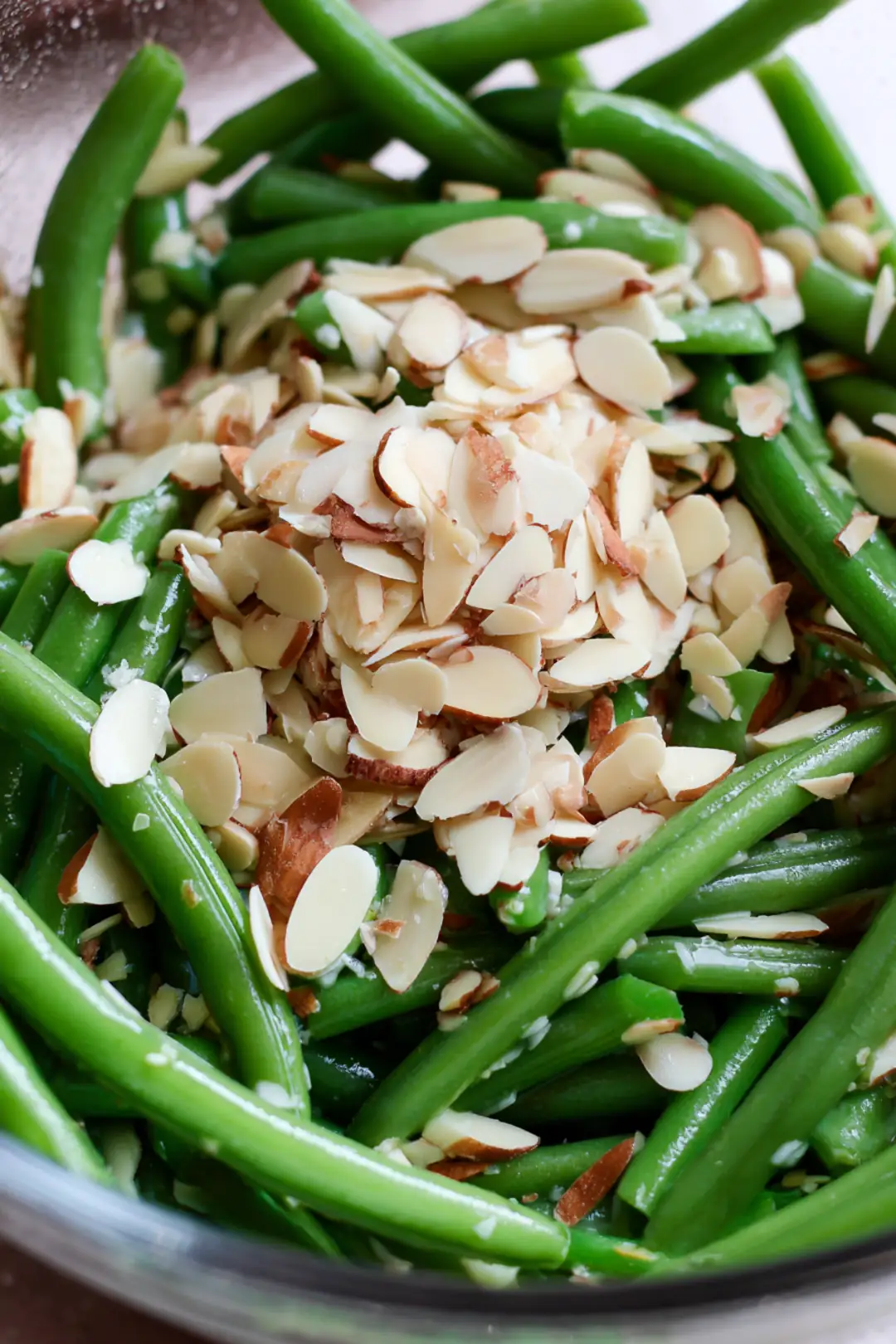 Add almond slivers to green beans and cook in air fryer