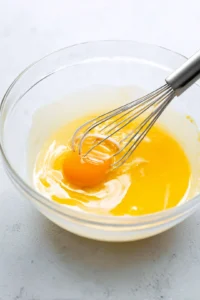 Add egg yolk and vanilla extract and mix until well combined