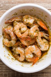 Add the large shrimp to the bowl and toss until they are coated evenly with the marinade. Let it sit for about 5 minutes to absorb the flavors.