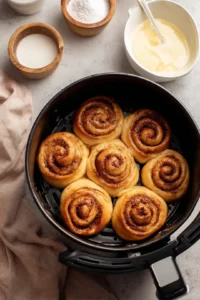 Air fry cinnamon rolls for 10 minutes or until golden brown and prepare glaze with butter cinnamon powdered sugar and milk