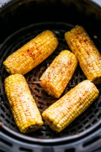 Air fry for 10 minutes, flipping halfway through, then season with butter, salt, pepper, and paprika before serving.