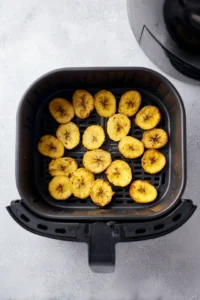 Arrange coated plantain slices in a single layer in the air fryer