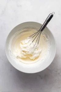 Beat softened cream cheese until creamy and mix in sugar and vanilla extract.