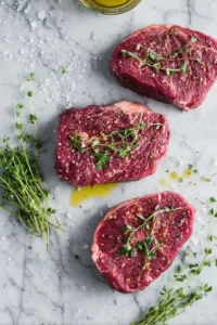 Brush sous vide steaks with olive oil and sprinkle with fresh herbs while the air fryer is preheating