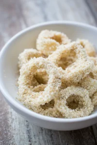 Coat calamari rings in breadcrumb mixture