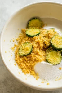 Coat pickles with flour, egg, and breadcrumbs then place in air fryer