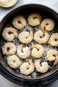 Coat shrimp in flour and egg wash, then coat with coconut-panko mixture
