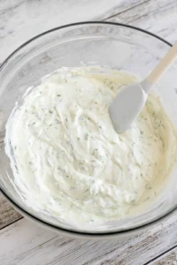 Combine buttermilk, mayonnaise, dill, and garlic powder to create ranch dip